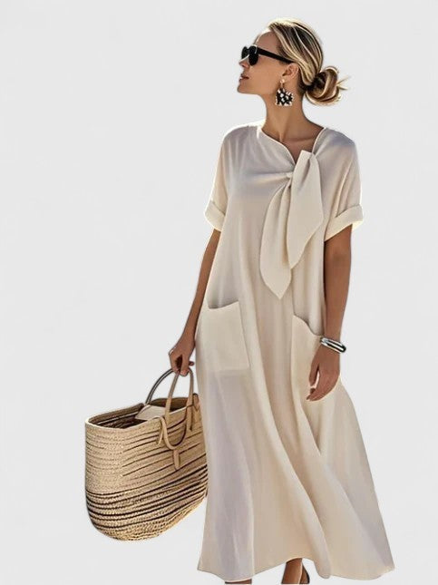 Cream maxi dress featuring tie-neck collar and relaxed short sleeves
