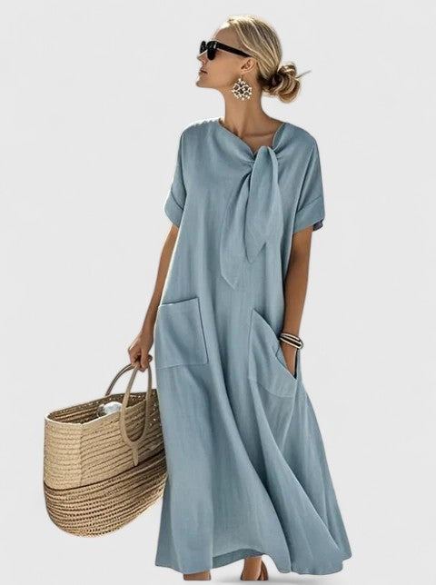 Light blue maxi dress with tie-neck design and oversized front pockets