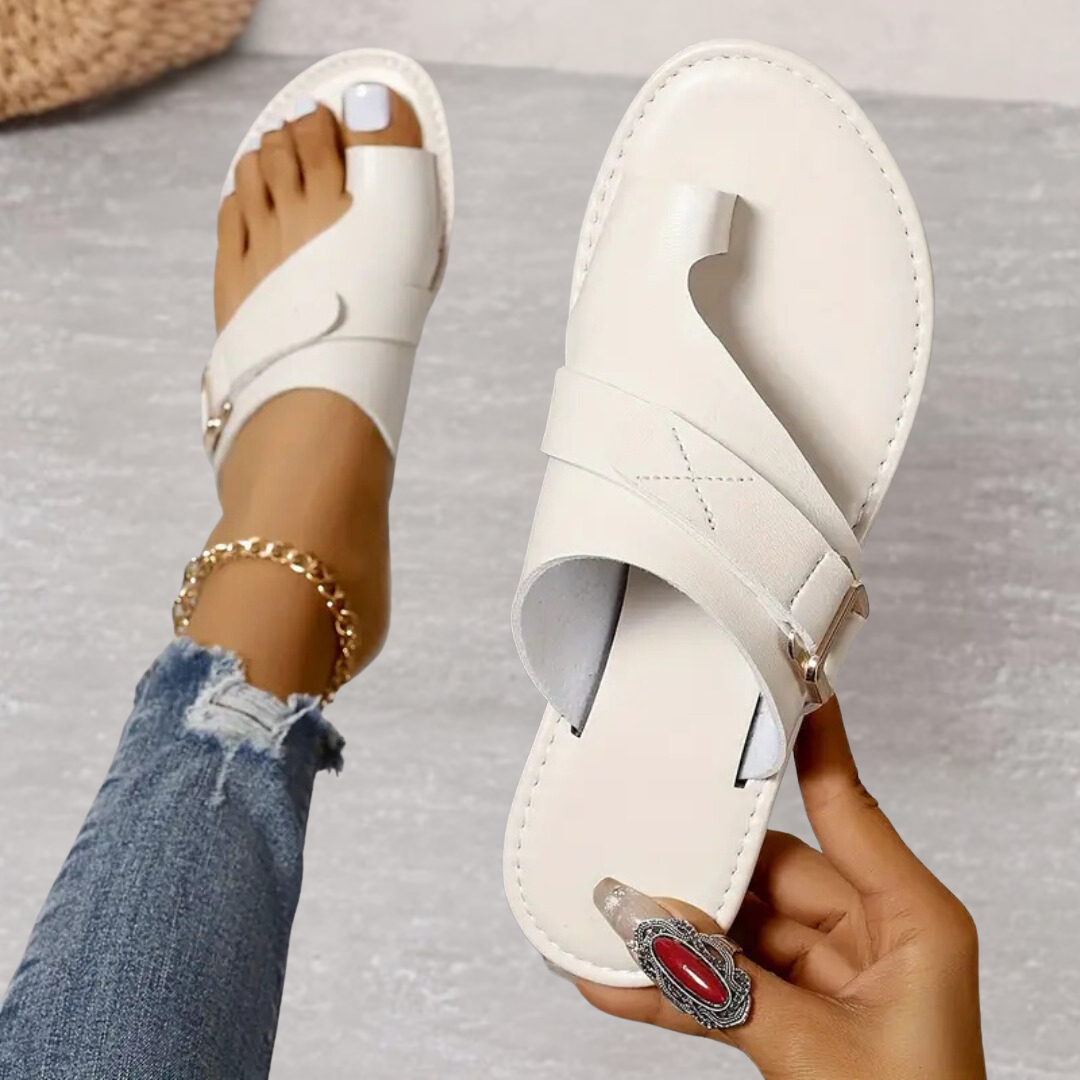 White leather toe-loop sandals with buckle strap and cushioned footbed