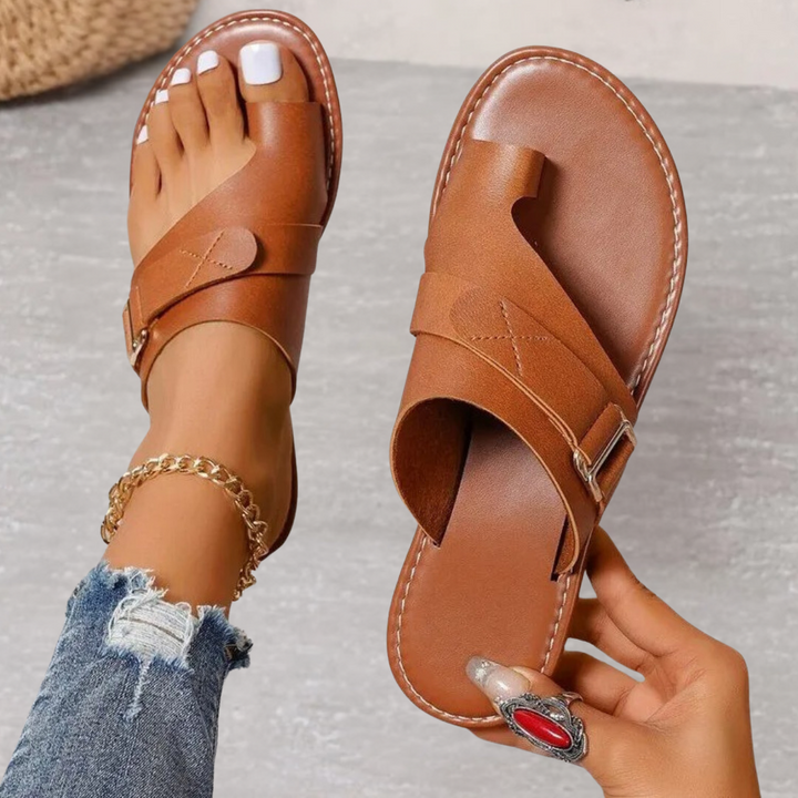 Brown leather toe-ring sandals featuring buckle detail and comfort sole