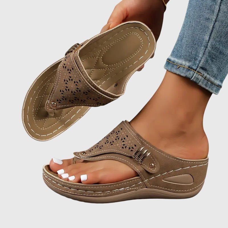 Taupe orthopedic wedge sandal with laser-cut floral pattern and stitched footbed