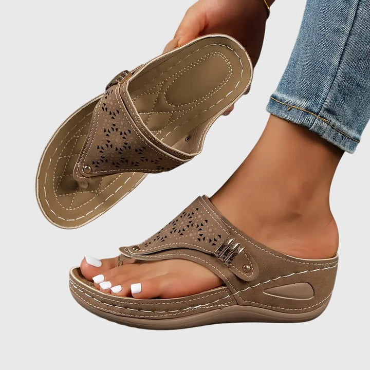 Taupe orthopedic wedge sandal with laser-cut floral pattern and stitched footbed