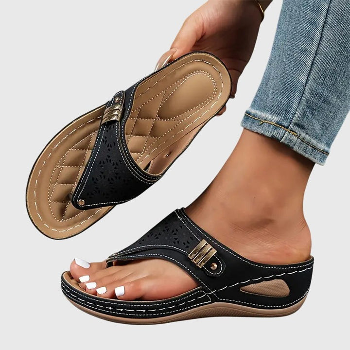 Black orthopedic wedge sandal with toe ring strap and contrast stitching detail