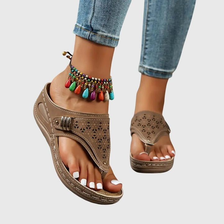 Taupe toe-ring sandal paired with colorful beaded anklet and low wedge sole