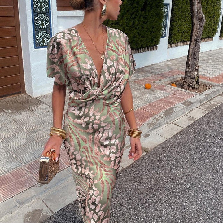 Close-up of twist-front bodice on green and pink leopard print wedding guest dress