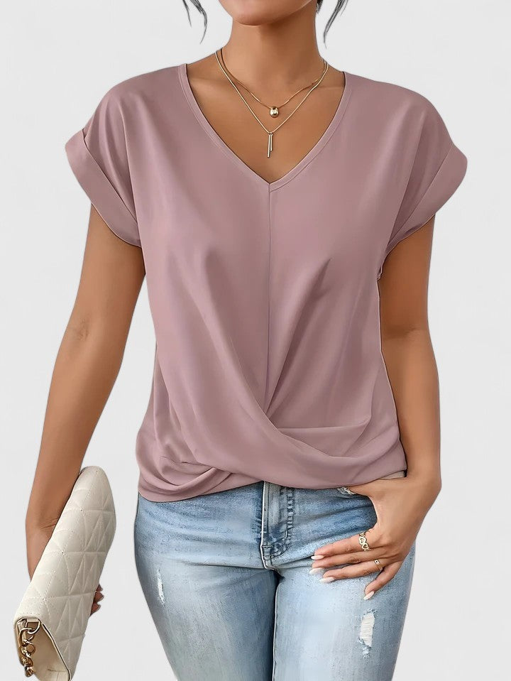 mauve pink V-neck top featuring cap sleeves and twist hem