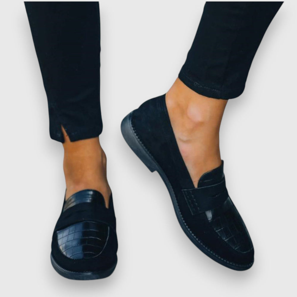 Suede black loafers featuring crocodile-textured panel and stitched trim detail