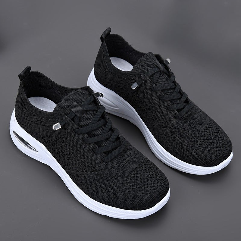 Black knit sneakers with white platform sole and air cushion heel