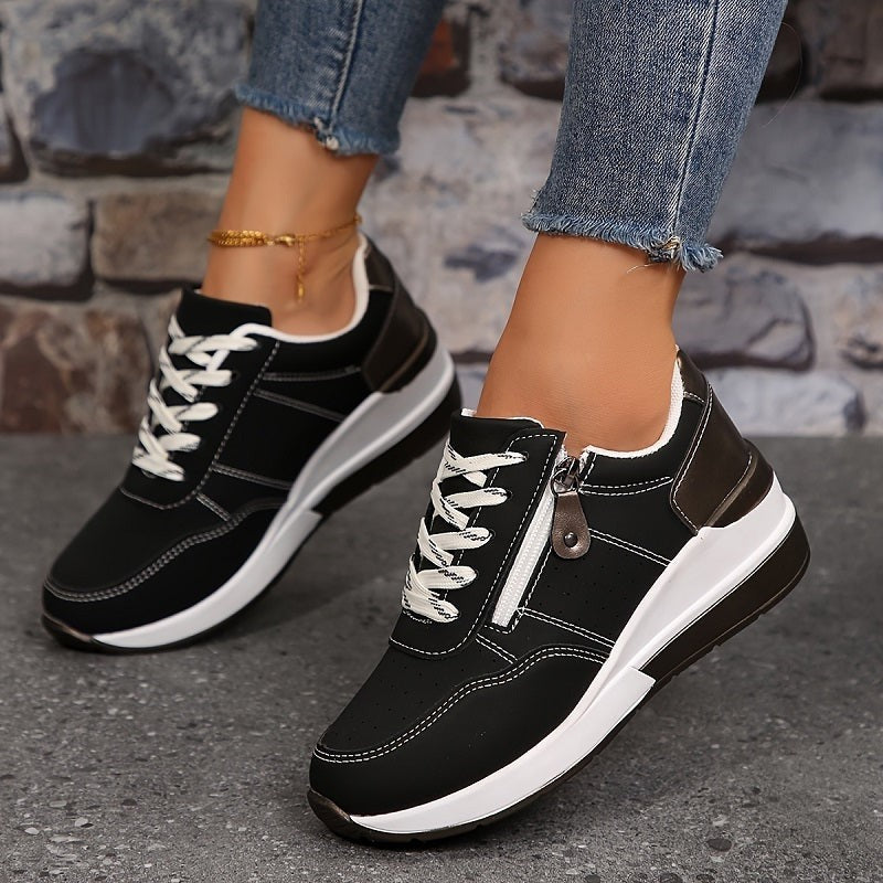 Black lace-up wedge sneakers featuring white platform sole and side zipper