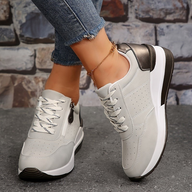 Gray lace-up sneakers with dark metallic heel and chunky white sole