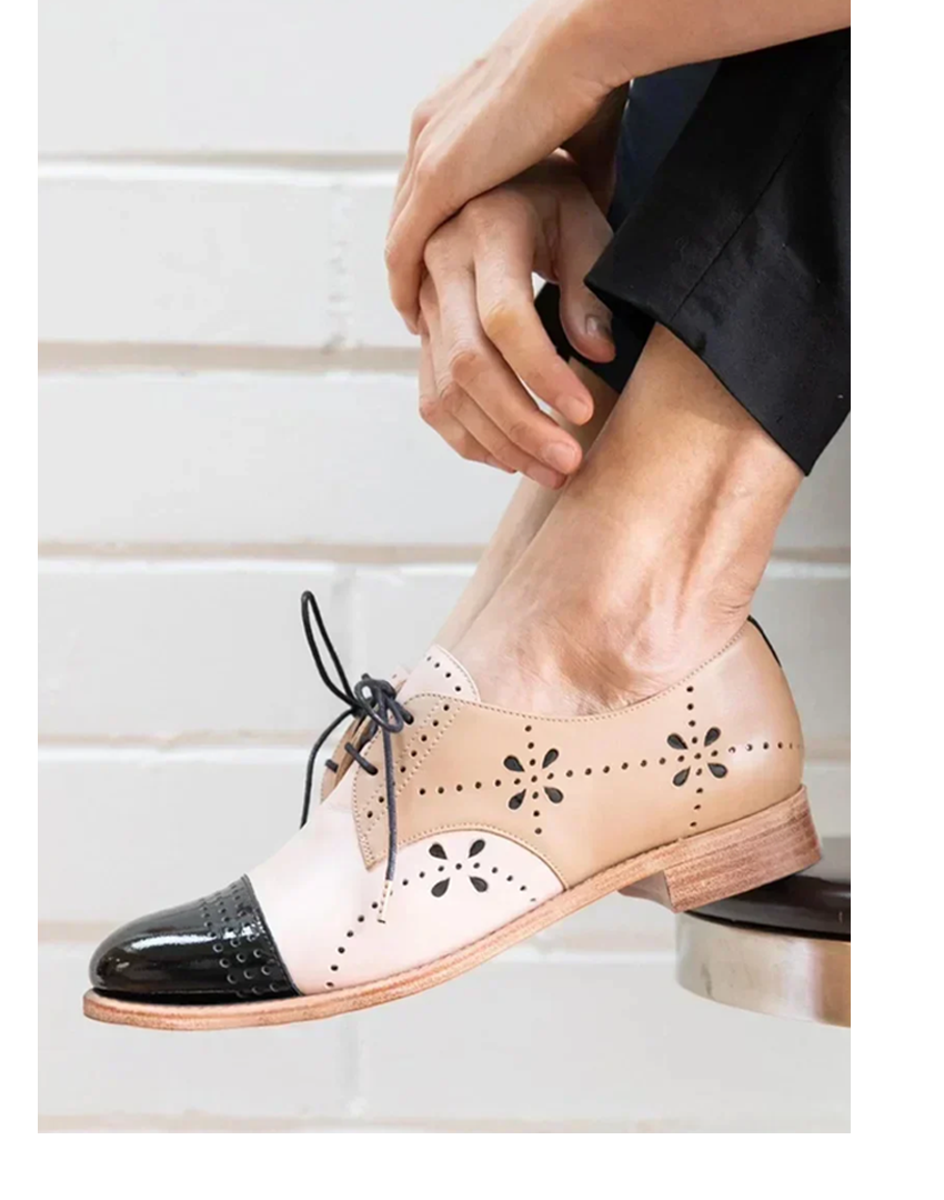 Two-tone leather oxford loafers with black patent cap toe and floral cutout detail