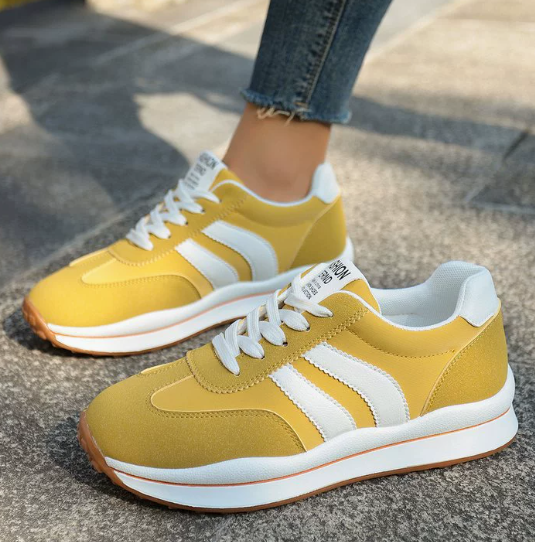 Yellow orthopedic sneakers with white stripes and lace-up design