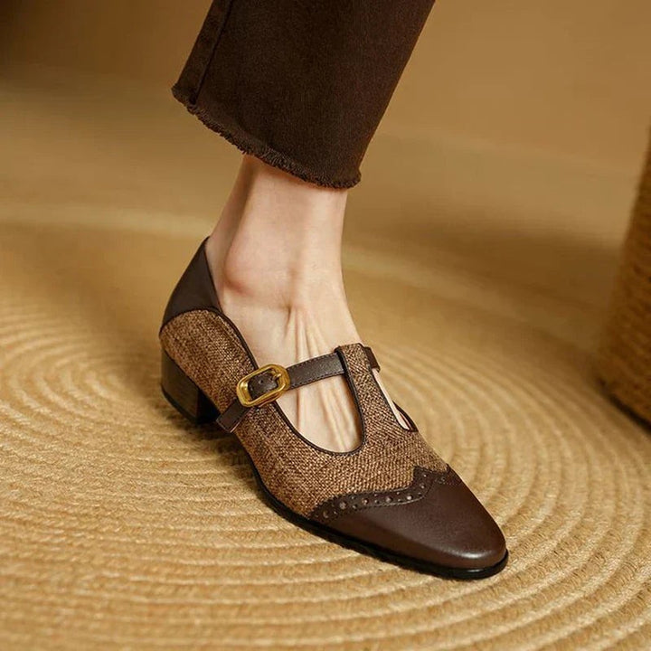 Vintage-style brown leather Mary Jane shoe with gold buckle and brogue toe