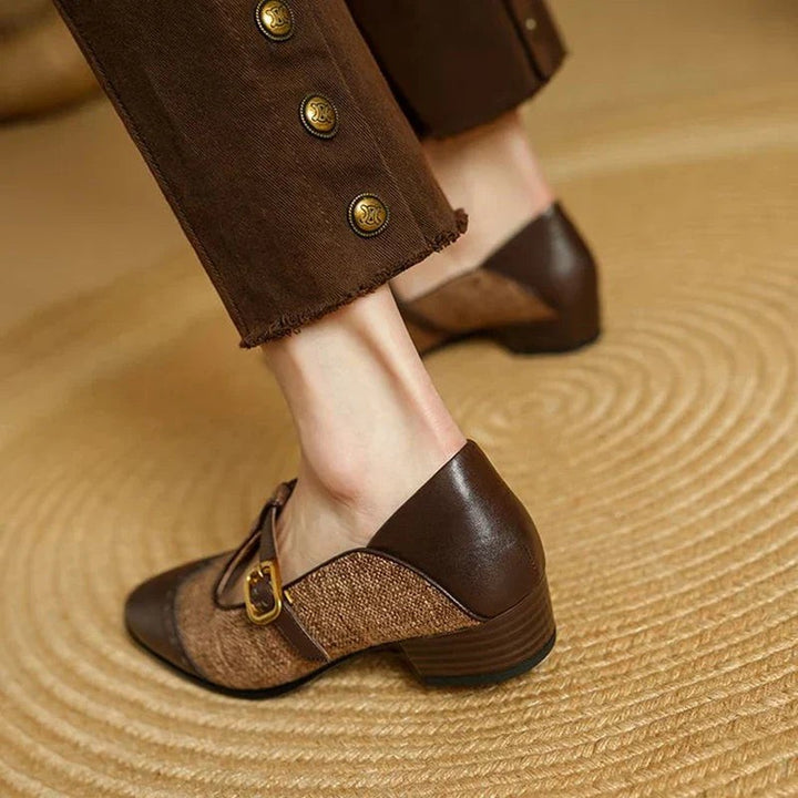 Two-tone brown Mary Jane pump with stacked block heel on woven mat
