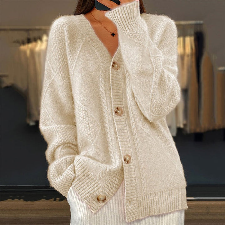 Cream cable-knit cardigan with V-neck styling and horn-style buttons