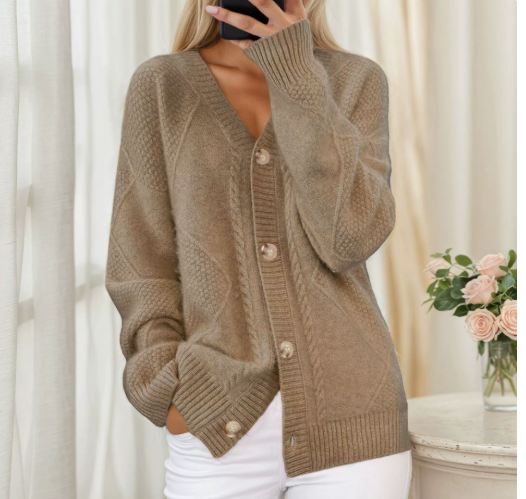 Taupe cable-knit cardigan worn with white trousers, button-front design