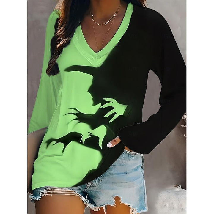 Green and black color-block V-neck top featuring spooky witch silhouette print