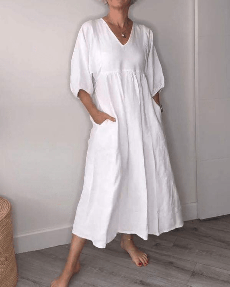White linen maxi dress with V-neck and half sleeves, side pockets