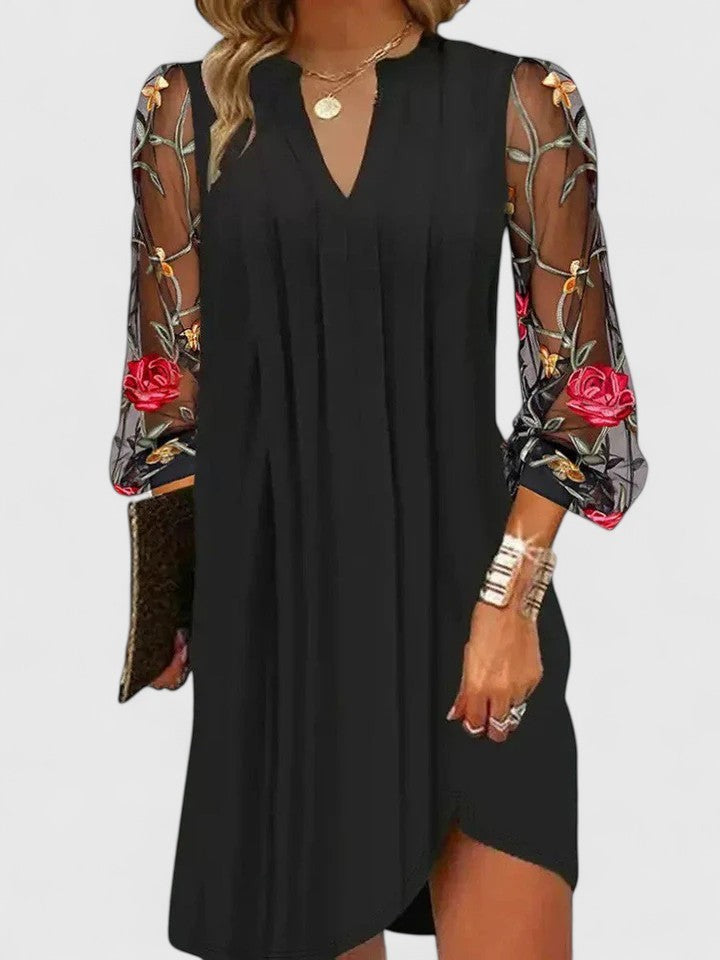 V-neck black shift dress featuring rose embroidered mesh sleeves