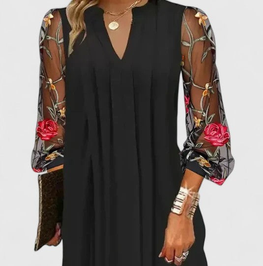 Black mini dress with sheer rose embroidered long sleeves, front view