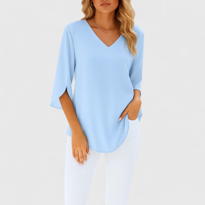 Light blue V-neck blouse with split three-quarter sleeves, flowy fit