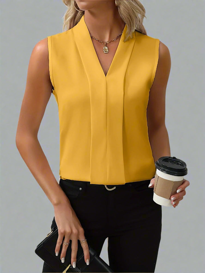 mustard yellow sleeveless top featuring pleated V-neck detail