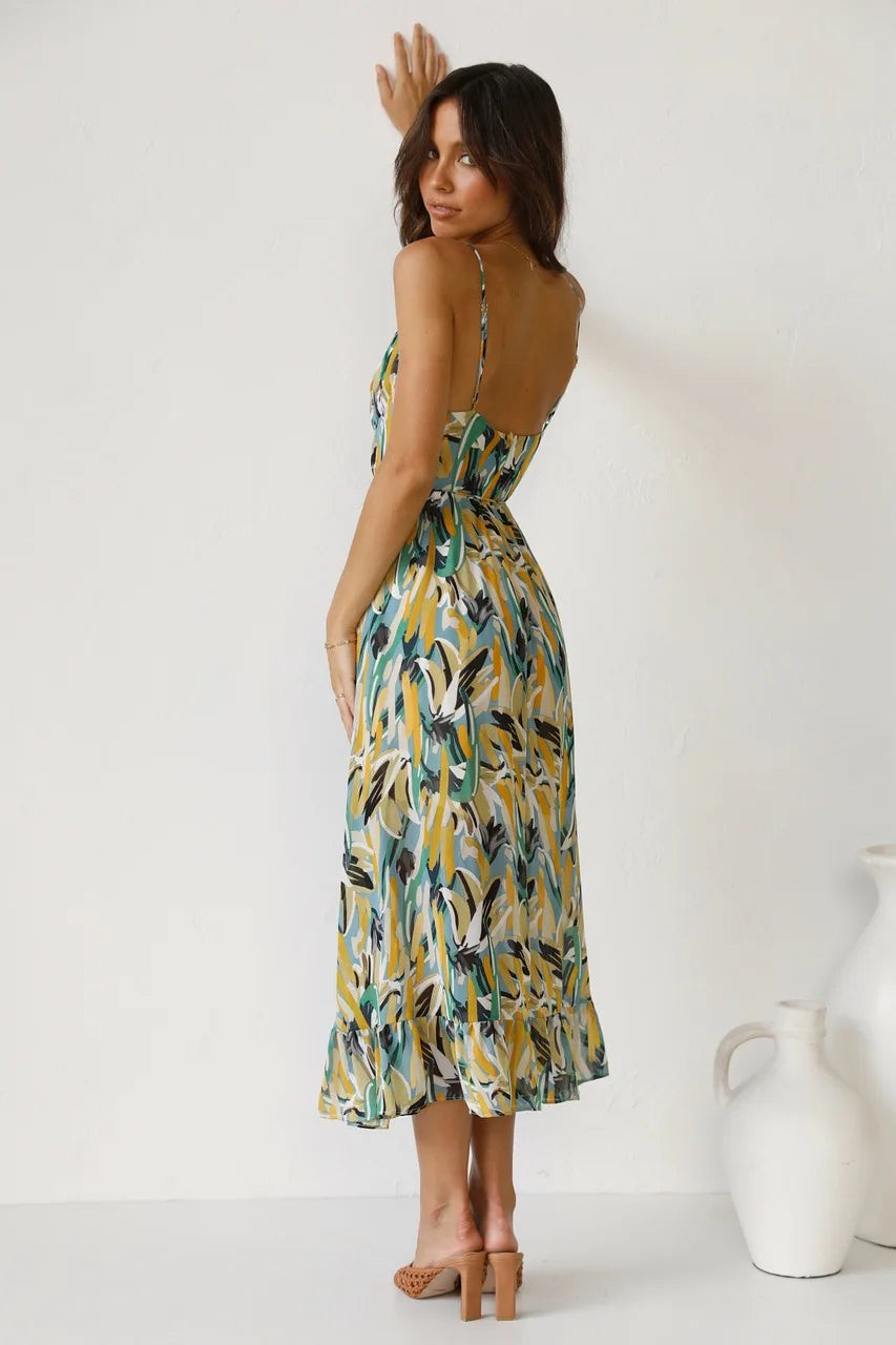 Open-back printed midi dress paired with braided strap heels
