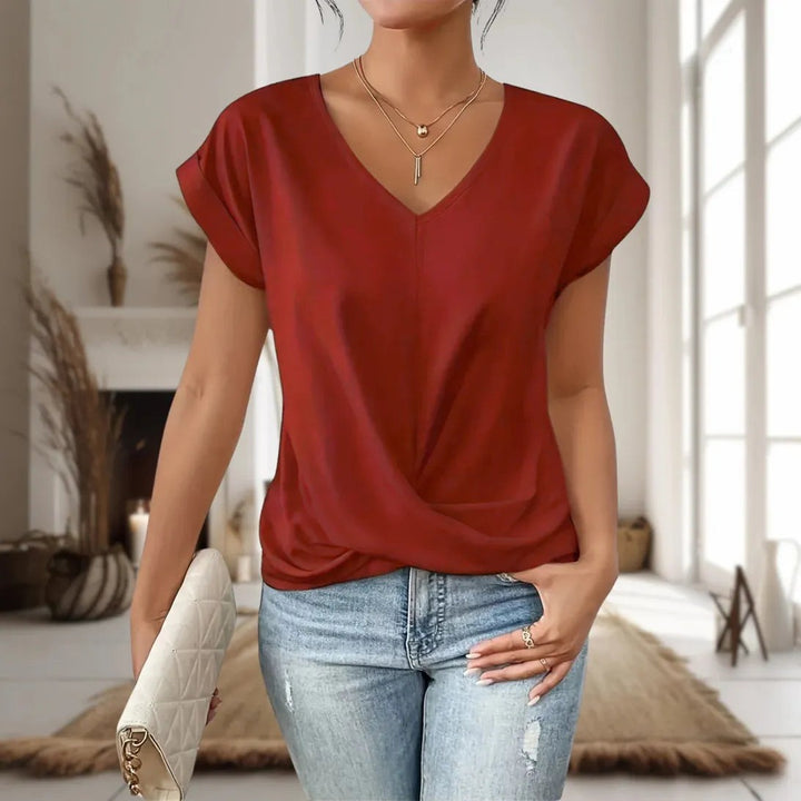 Rust red V-neck blouse with cap sleeves and gathered twist hem