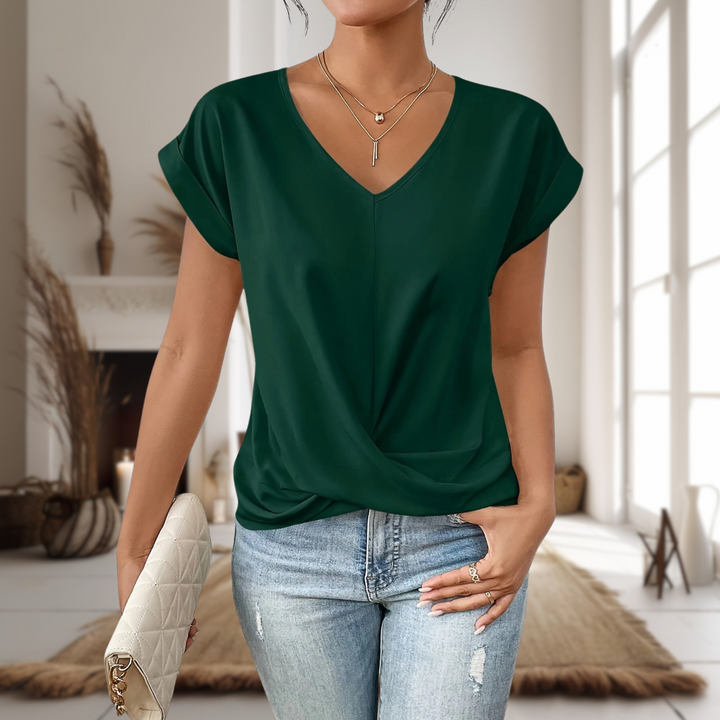 Emerald green V-neck top with cap sleeves and twist-front styling