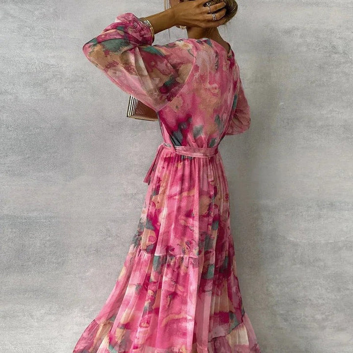 Back view of tiered maxi dress showing waist tie and long sleeves