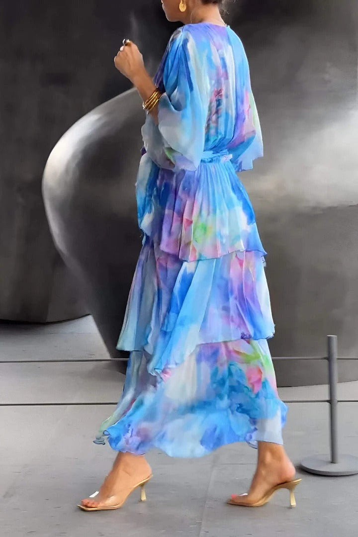 Side view of flowy blue floral maxi dress with tiered ruffles and sash
