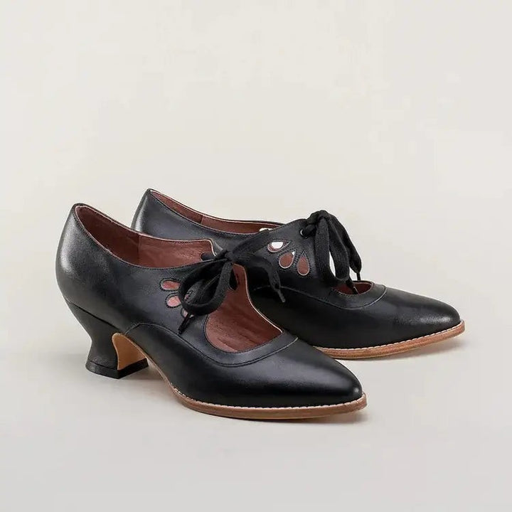 black leather vintage pin-up heels with teardrop cutouts and laces