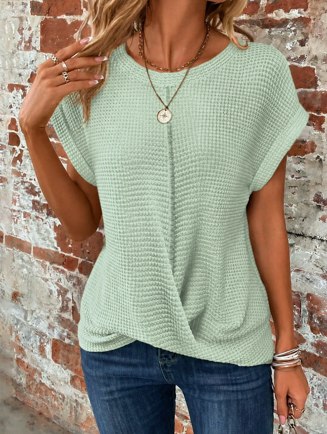 Sage green waffle knit tee with twist-front hem and cap sleeves