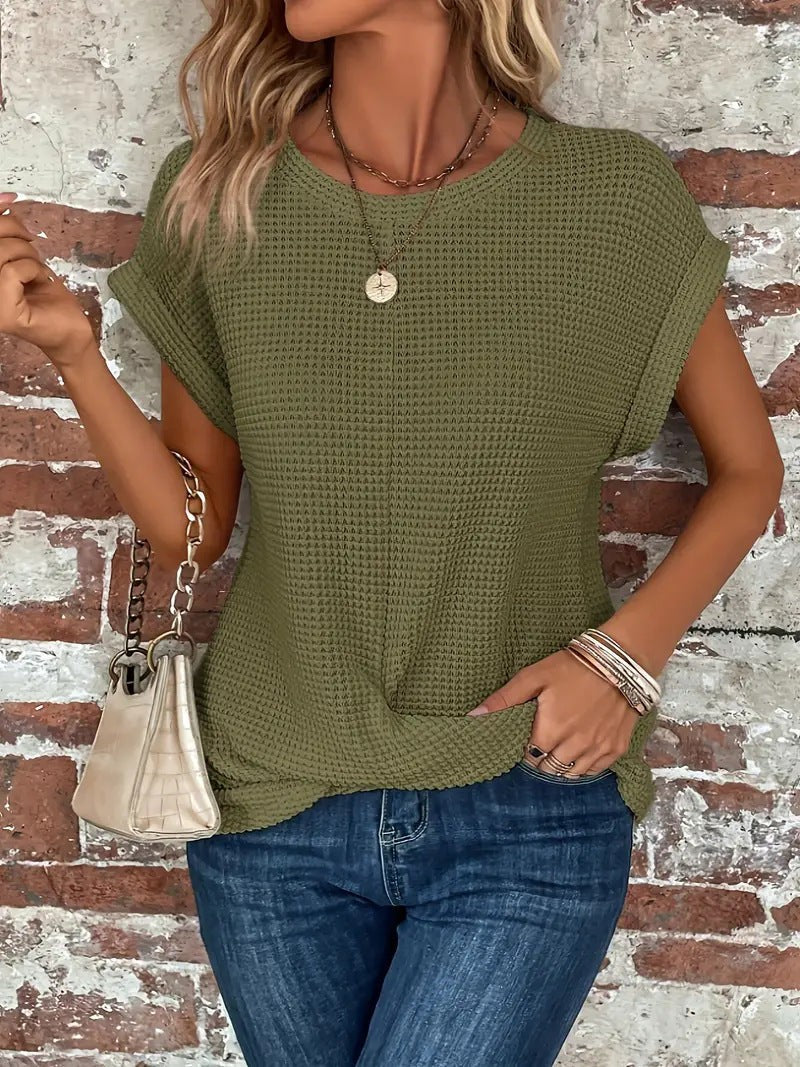 Olive green waffle knit tee styled with cap sleeves and twist hem