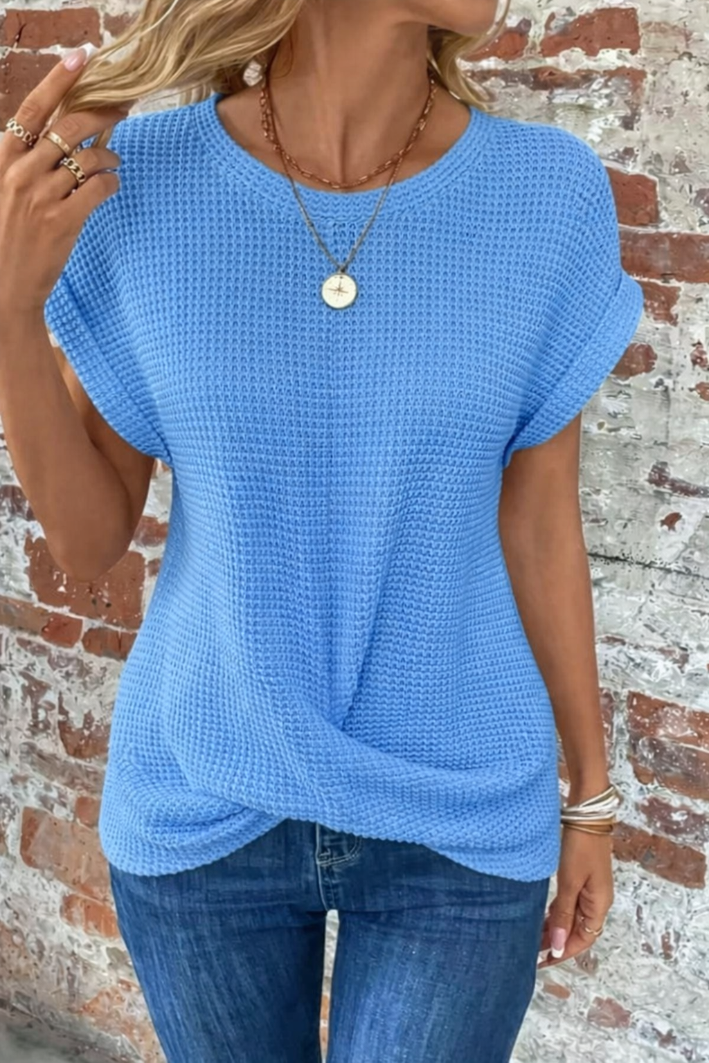 Sky blue waffle knit top with draped twist hem and round neck