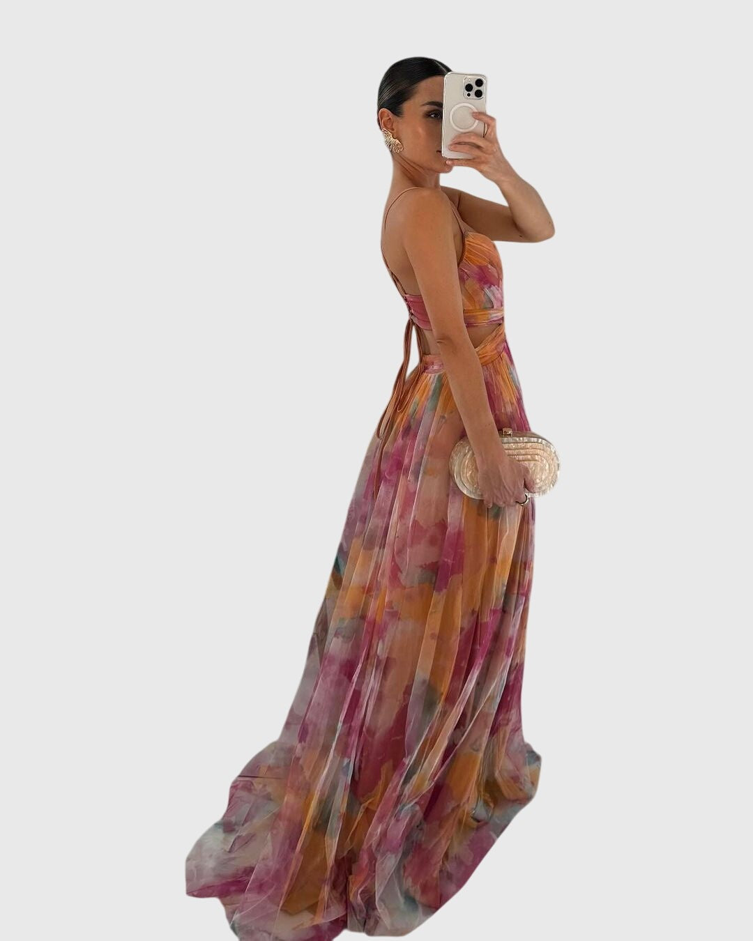 Side view of floral tulle maxi dress with crossed waist straps and train