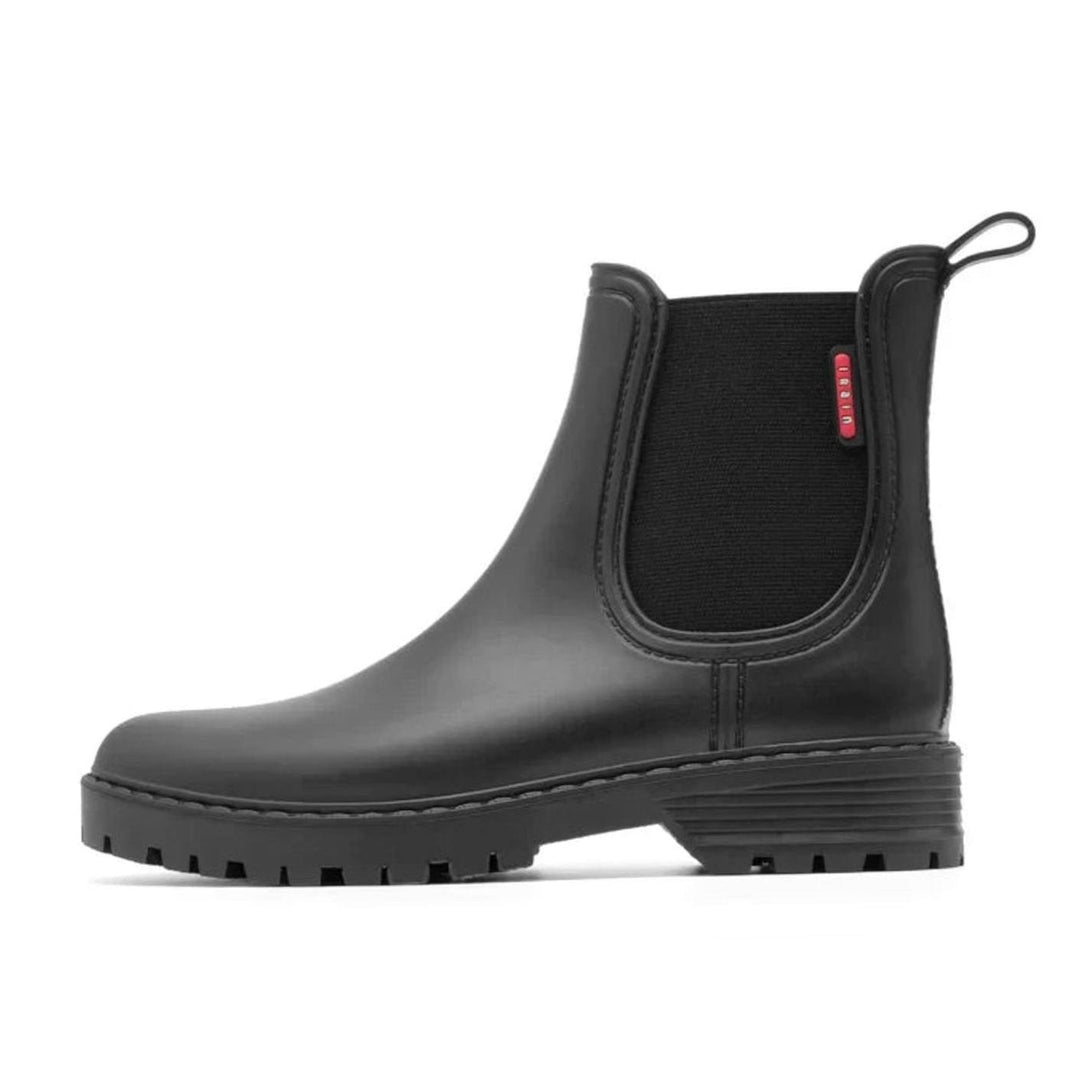 Side profile of black Chelsea boot showing elastic gusset and pull tab detail