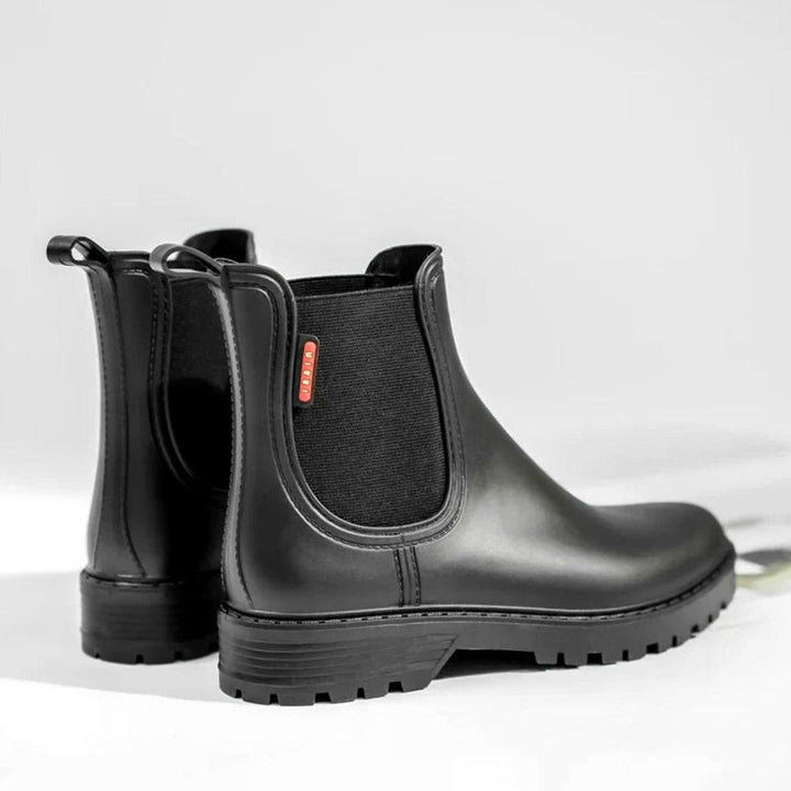 Rear view of black Chelsea boots highlighting heel pull loops and tread sole