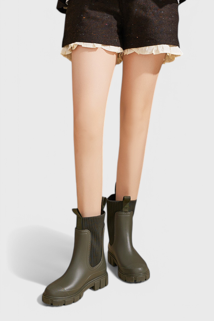 close-up of olive Chelsea boot on model's ankle and calf