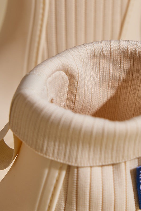 close-up of ribbed knit cuff and pull tab on cream boot
