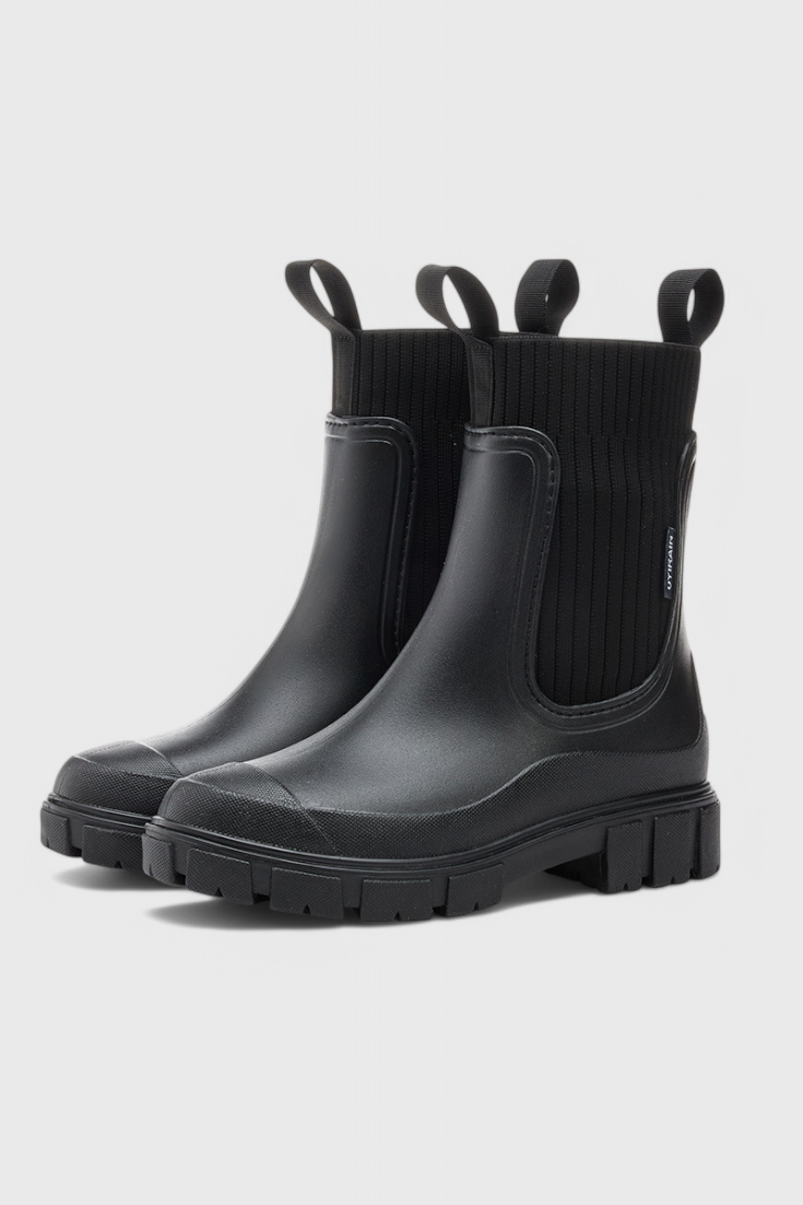 black waterproof Chelsea boots with chunky lug sole and pull tabs