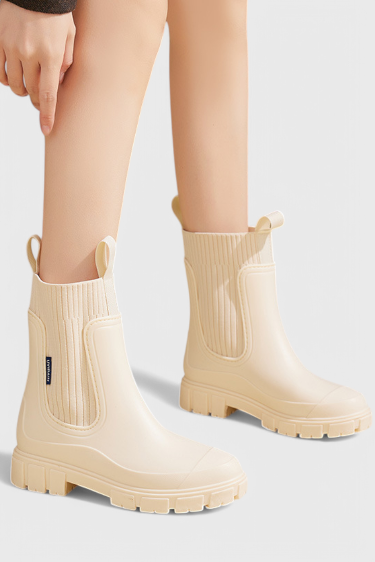 model wearing cream waterproof Chelsea boots with knit trim