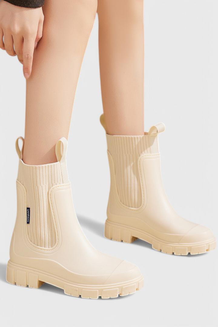 model wearing cream waterproof Chelsea boots with knit trim