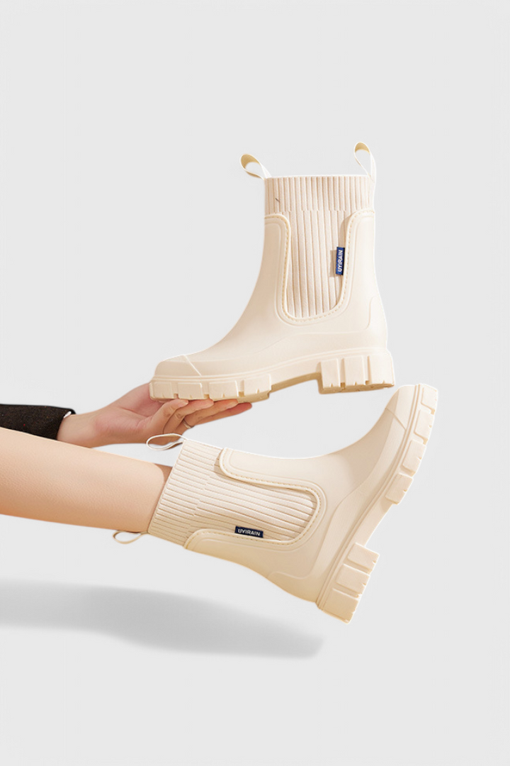 cream Chelsea rain boots displayed side by side with pull loops