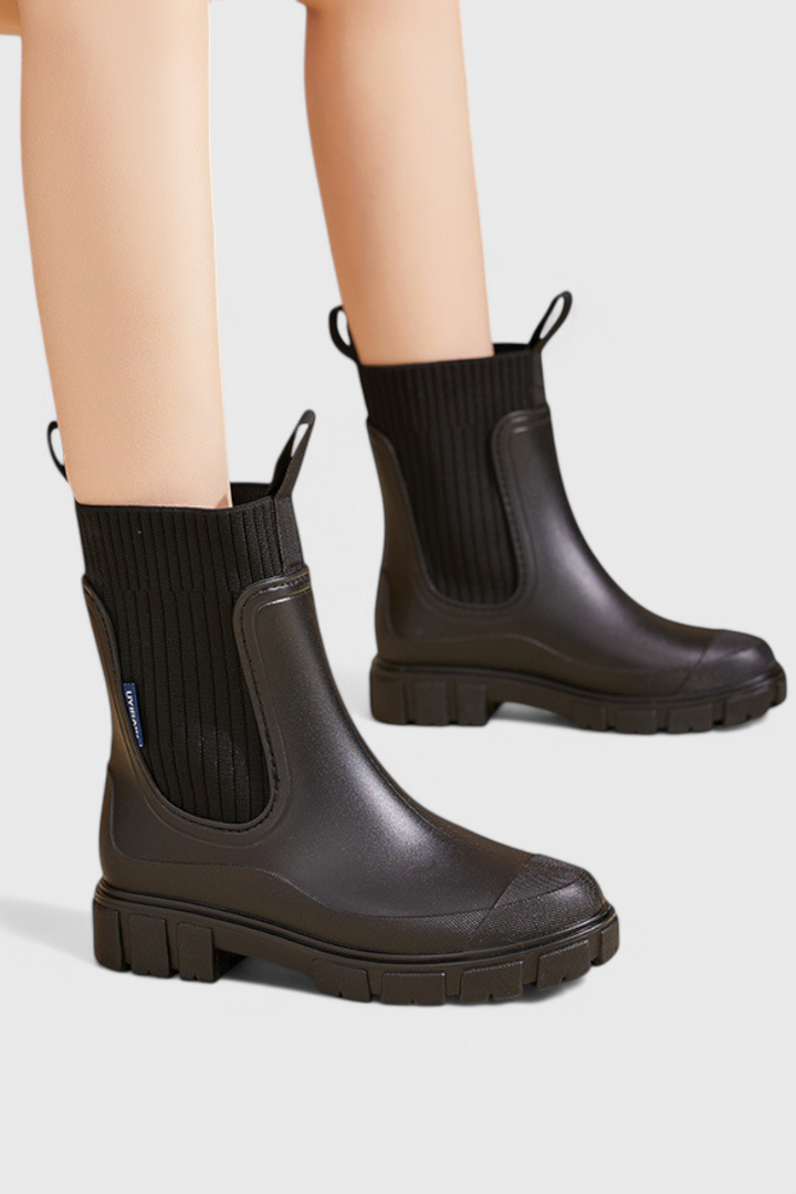 close-up of black Chelsea rain boot showing knit ankle cuff