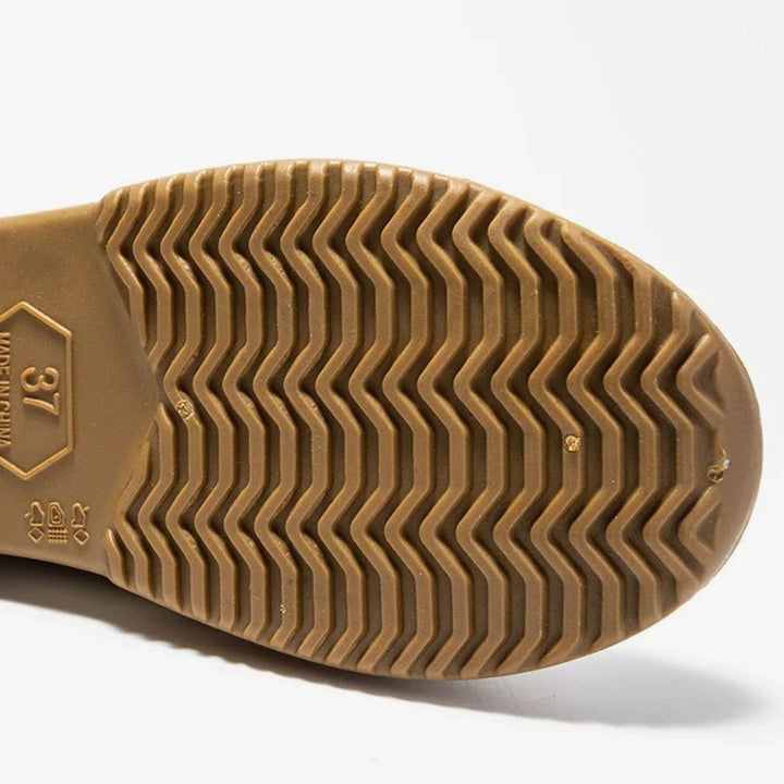 Close-up of tan rubber sole showing chevron tread pattern