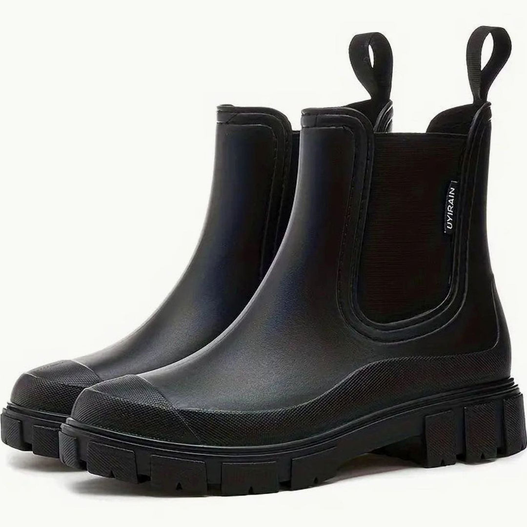 Black waterproof Chelsea boots with matte finish and lug-sole platform