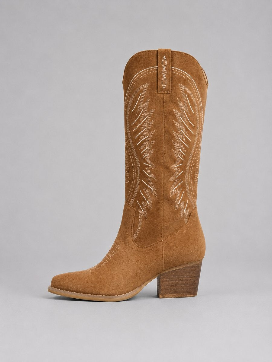 Side view of tan cowboy boot showing embroidered shaft and heel