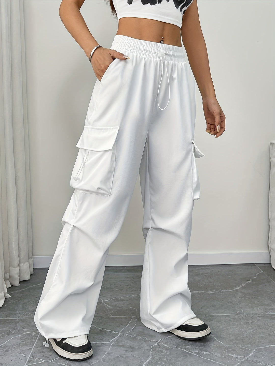 White wide-leg cargo pants with drawstring waist and side pockets