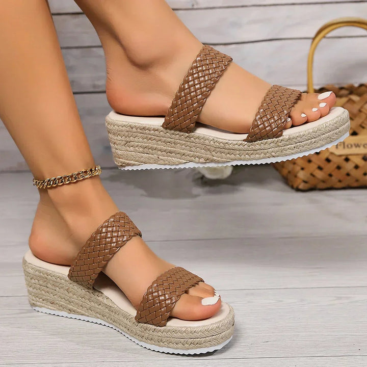 Brown woven double-strap espadrille wedge sandal shown on model's foot